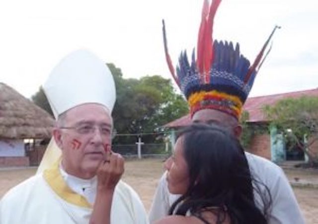 Cardinal Baretto having his face painted by natives.